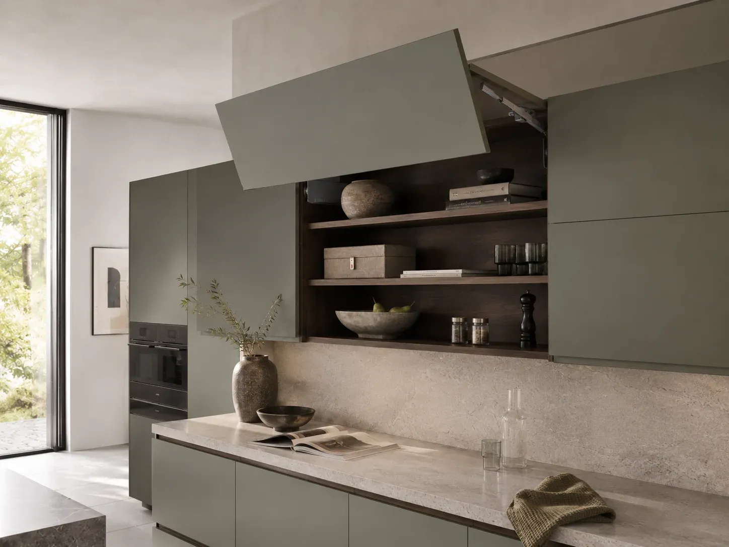 Cocina integral premium en tono verde oliva con herrajes integrados de alta ingeniería